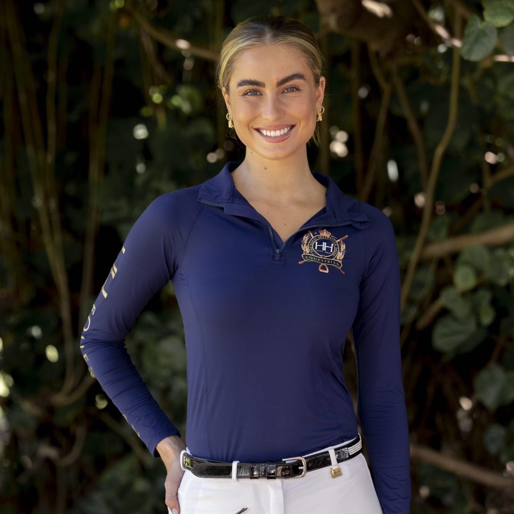 navy equestrian top with gold logo on smiling lady