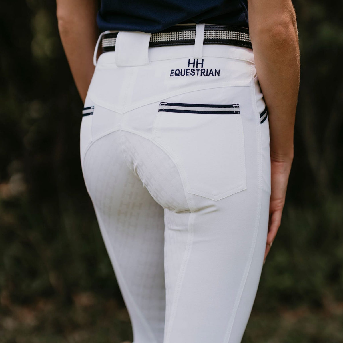 White breeches with stripes on pockets, grip seat and belt loops.