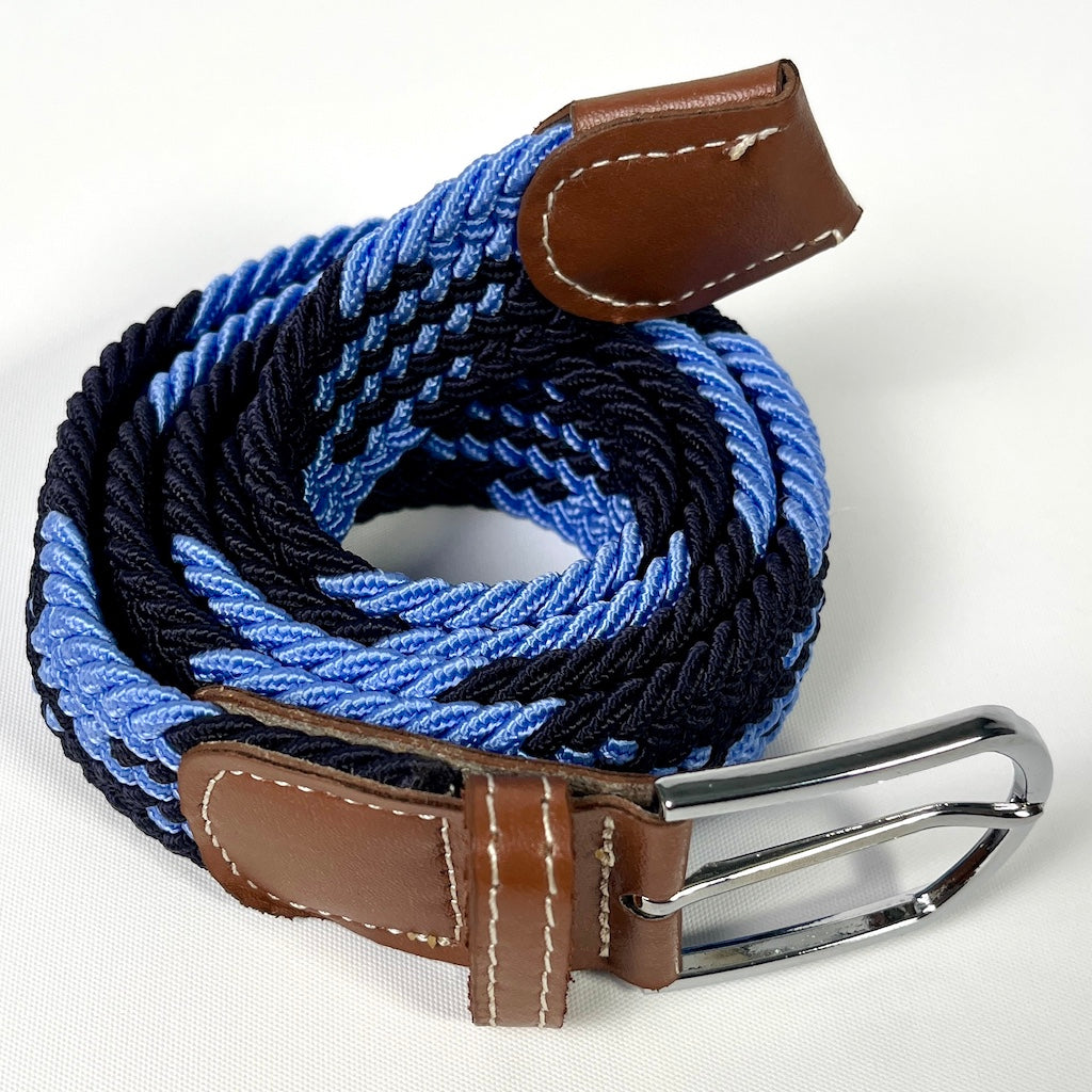 Elastic belt of various blues with silver buckle and brown leather ends.