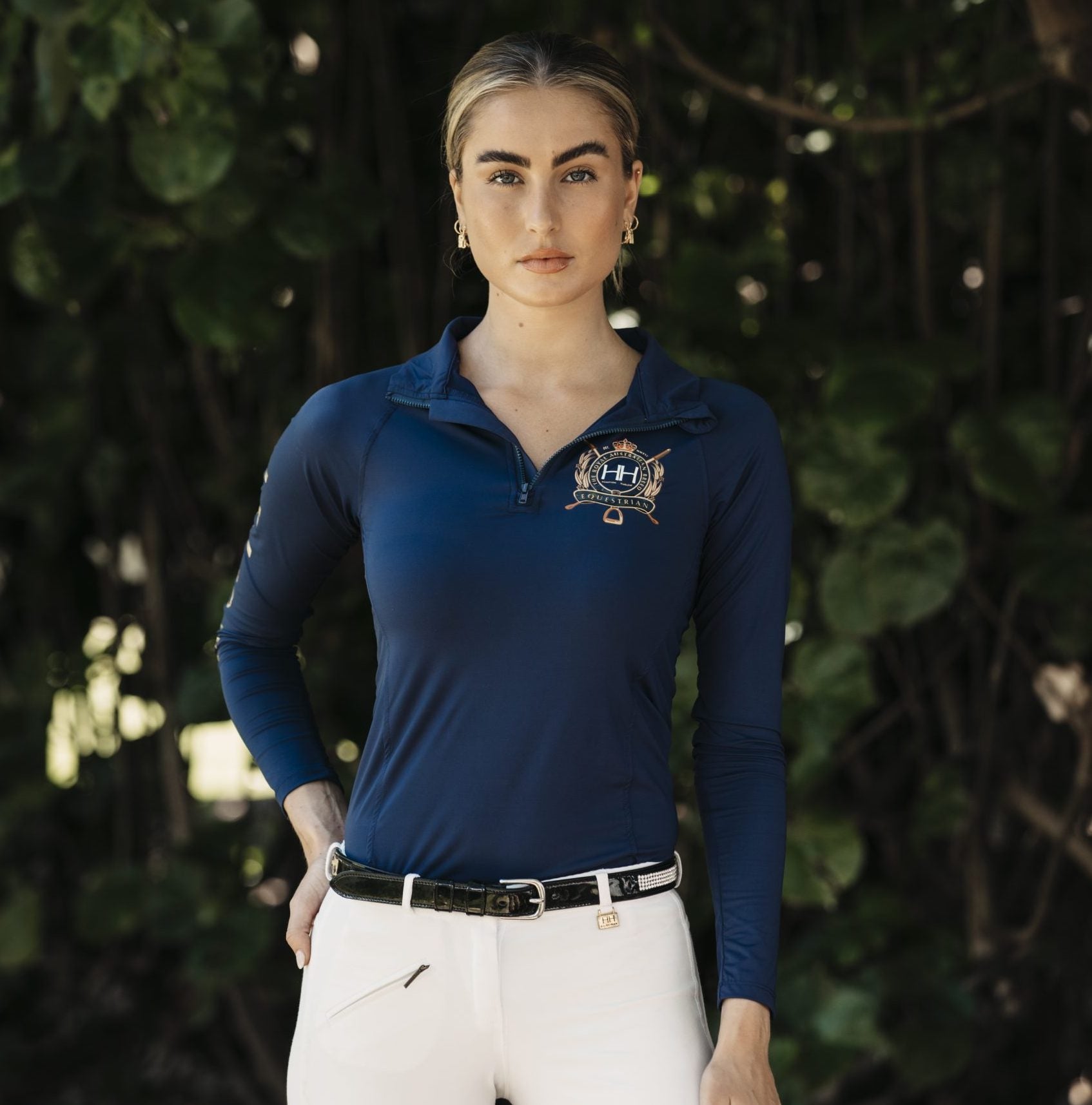 navy equestrian top with gold logo on smiling lady