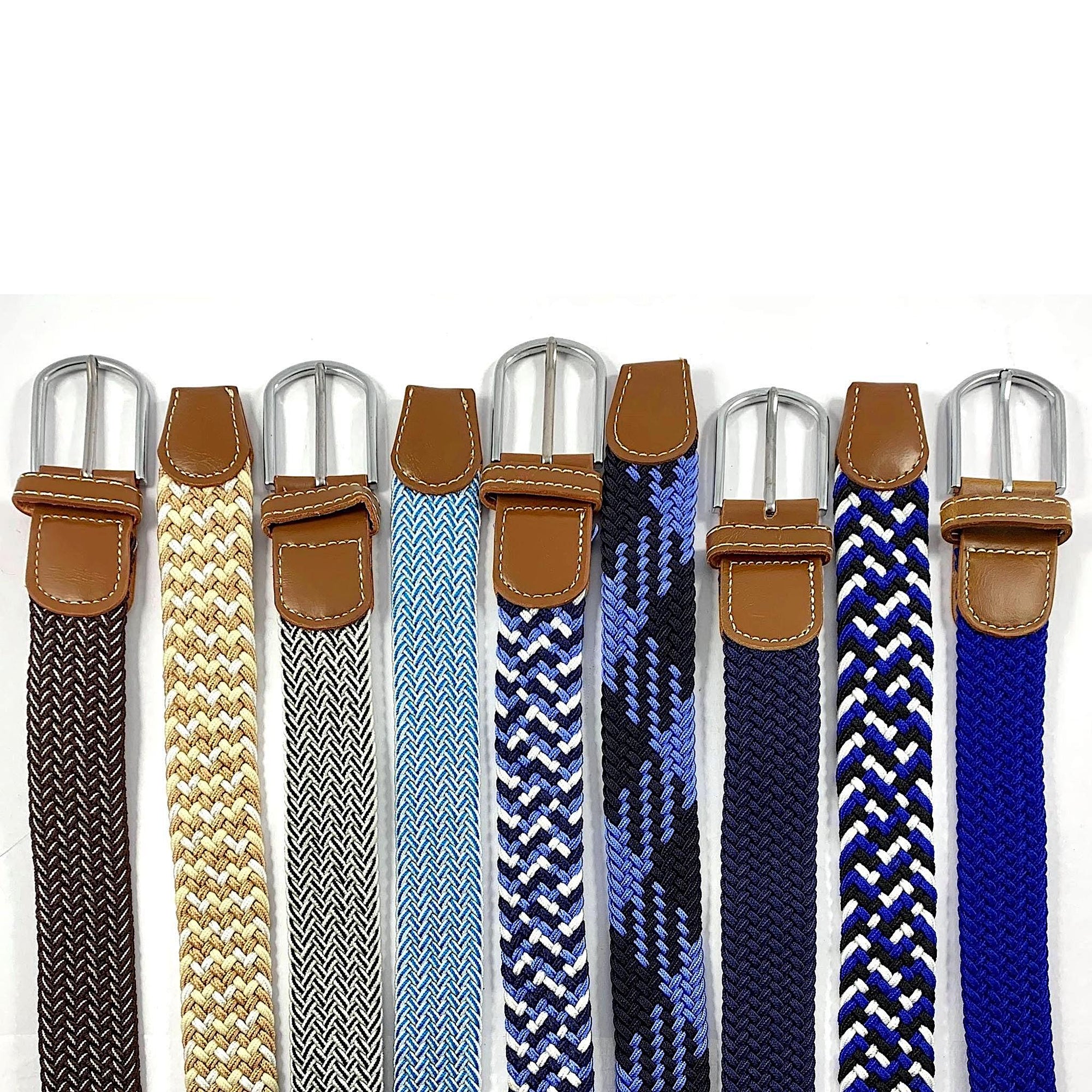 Varying coloured elastic belts, all with silver buckles and brown leather ends.