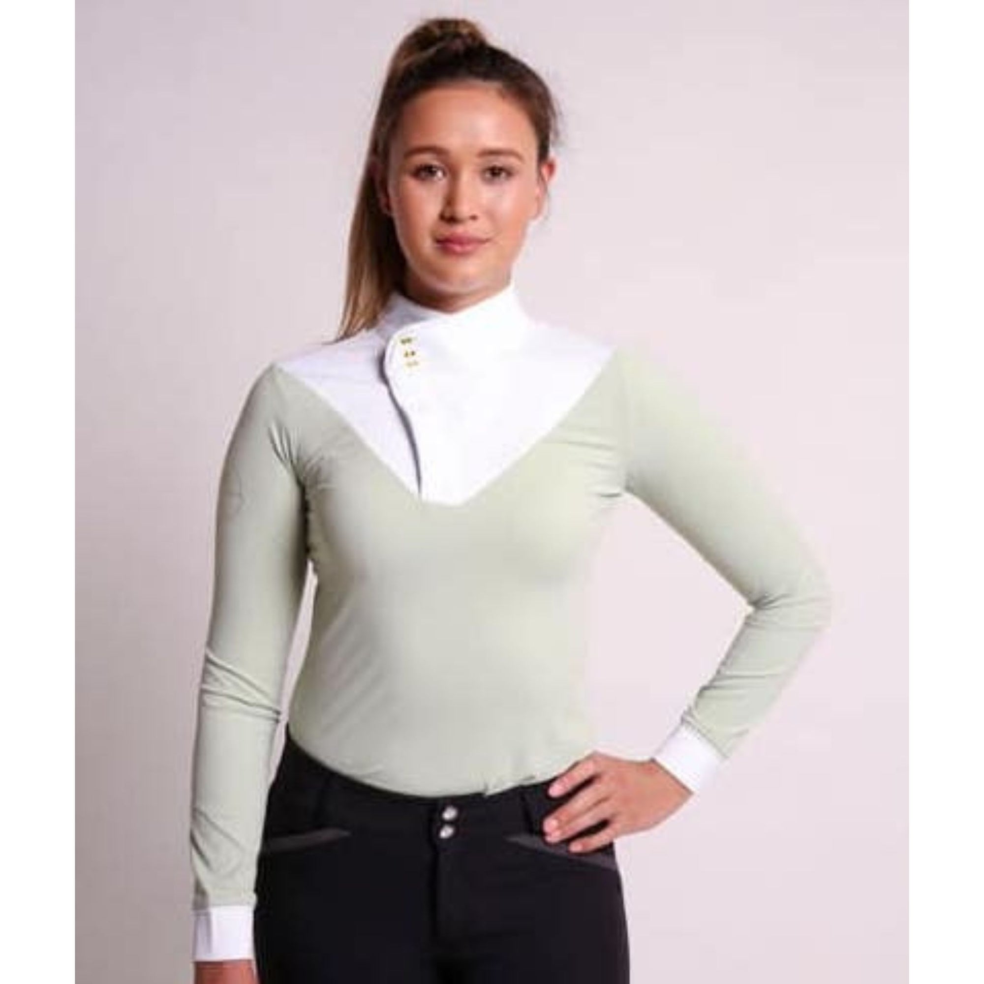 Front view of girl wearing long sleeve mint competition top.