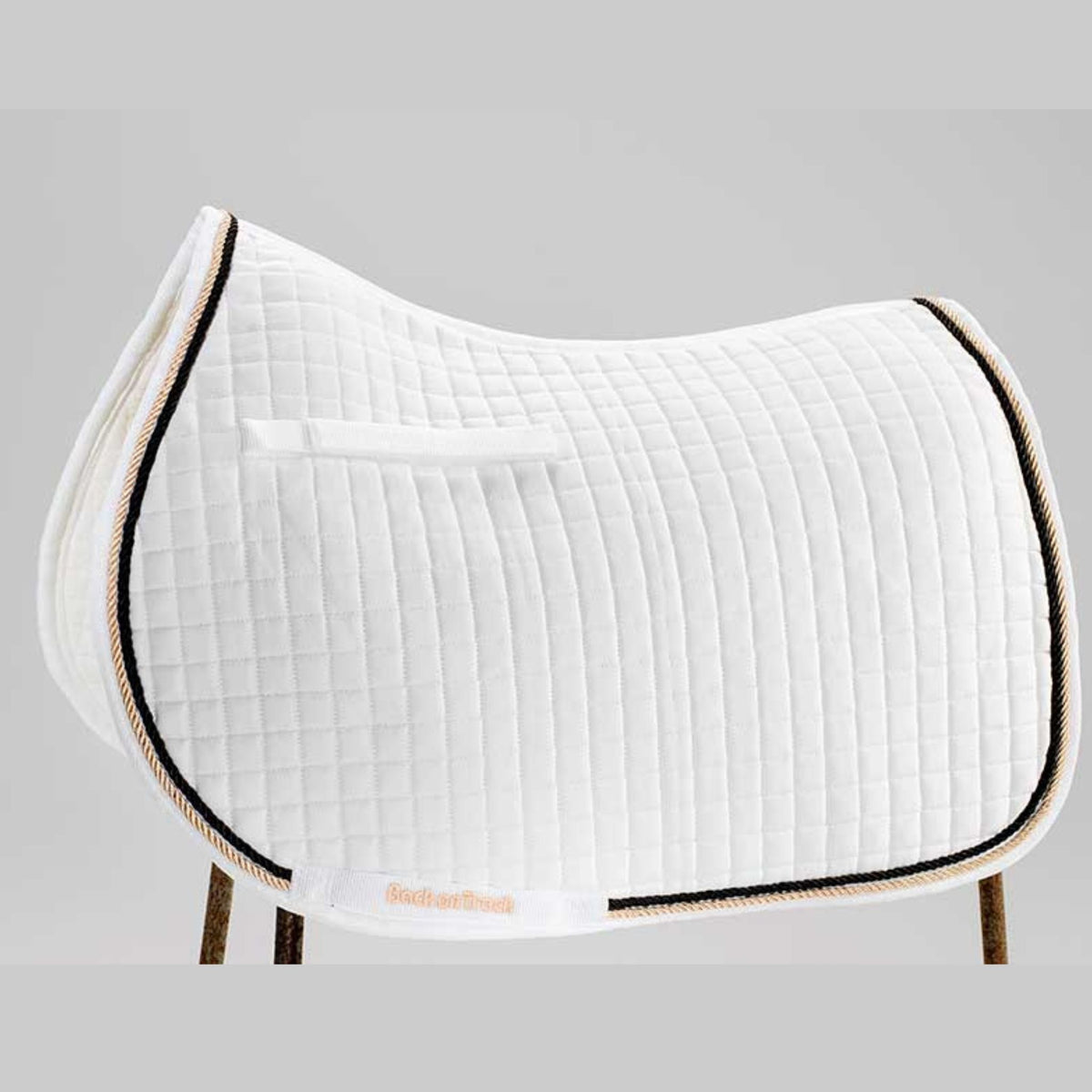 White saddle pad with gold and back trim, with keepers and a all purpose shape.