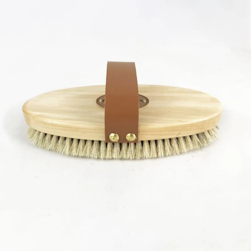 body brush with oval wooden handle with a leather strap and soft short bristles. 