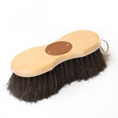 Brush with a slight hourglass shaped wooden handle, with long dark brown bristles.
