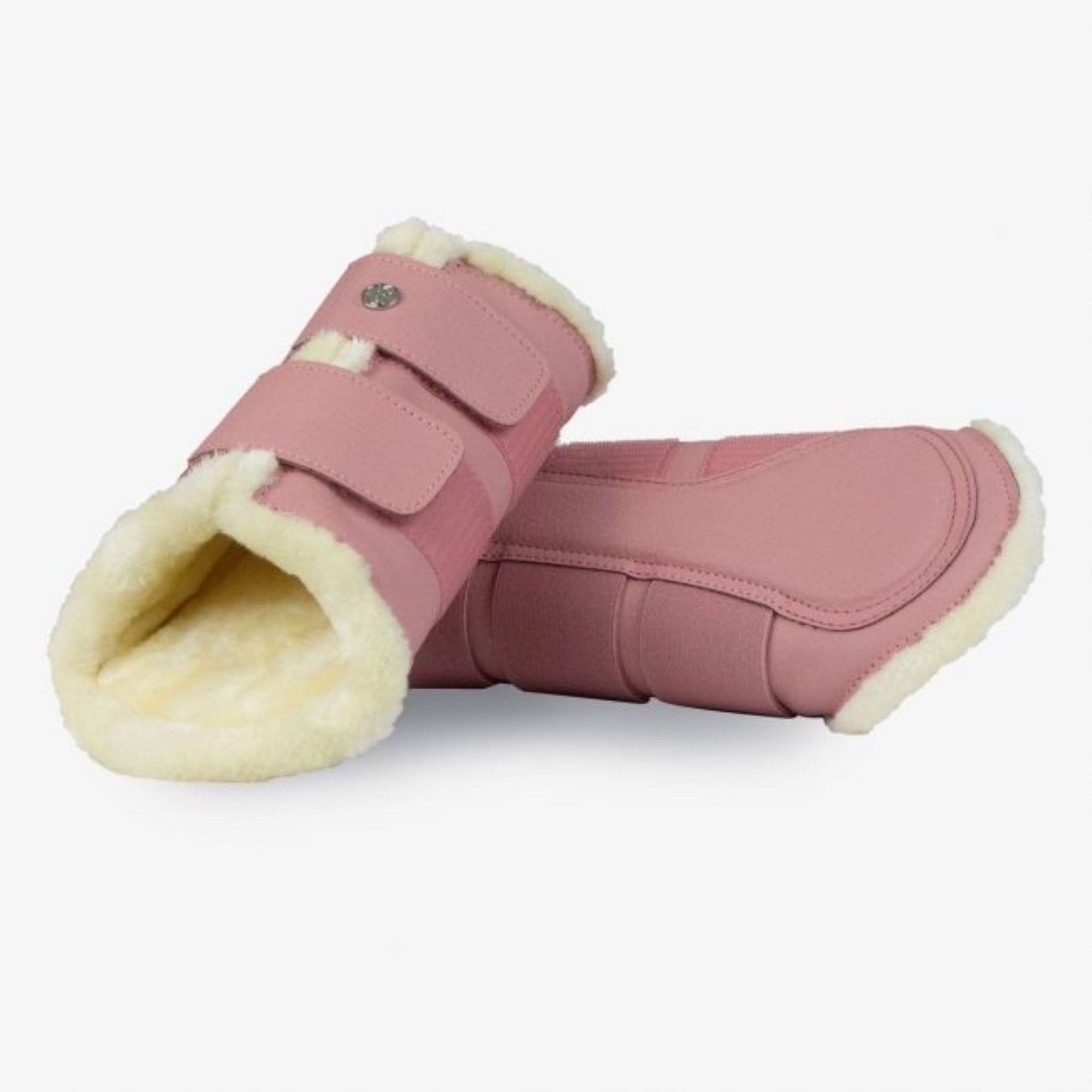 Blush colour brushing boots lined with white faux fur.