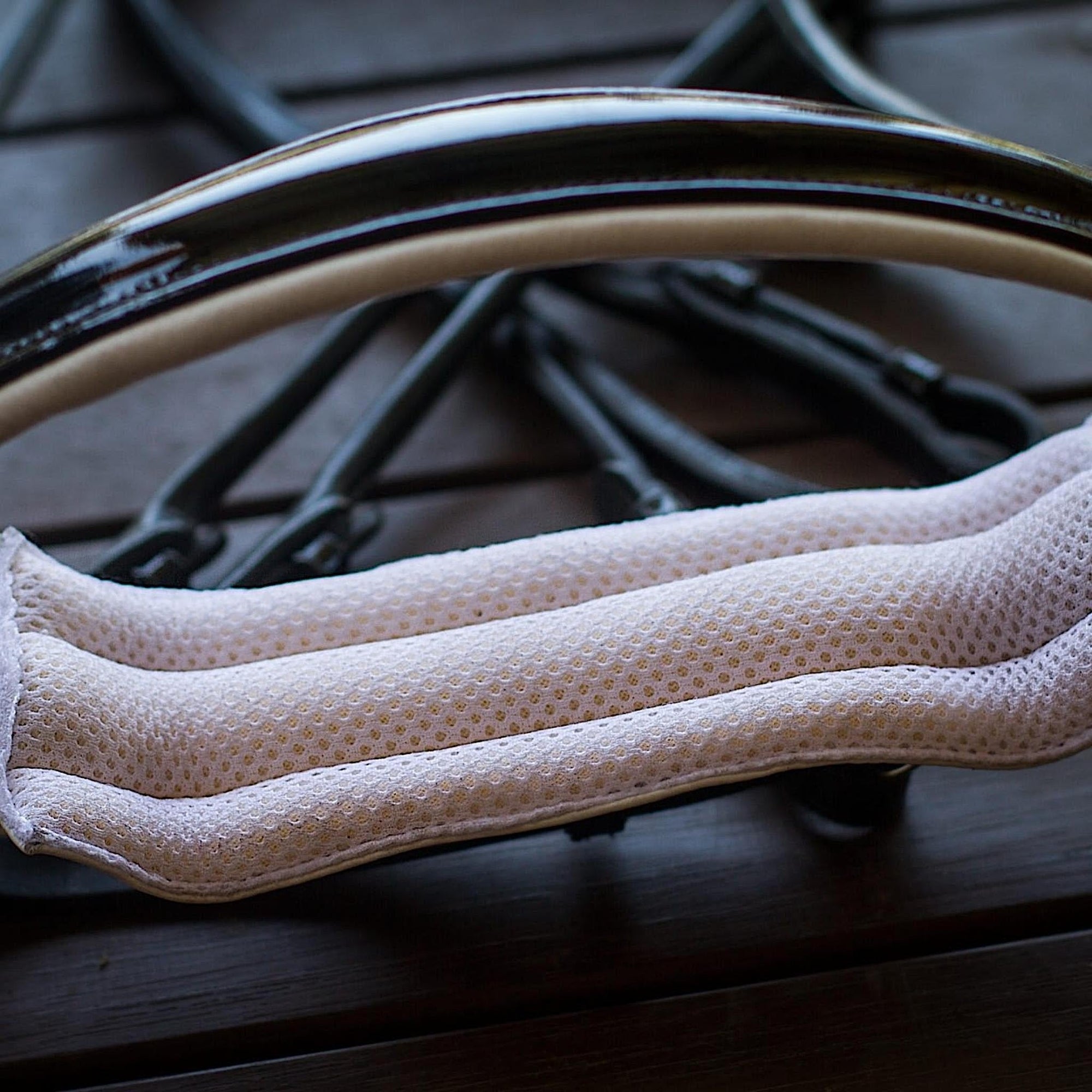 A bridle comfort pad showing its side made from white ventilated polyester-fibre.