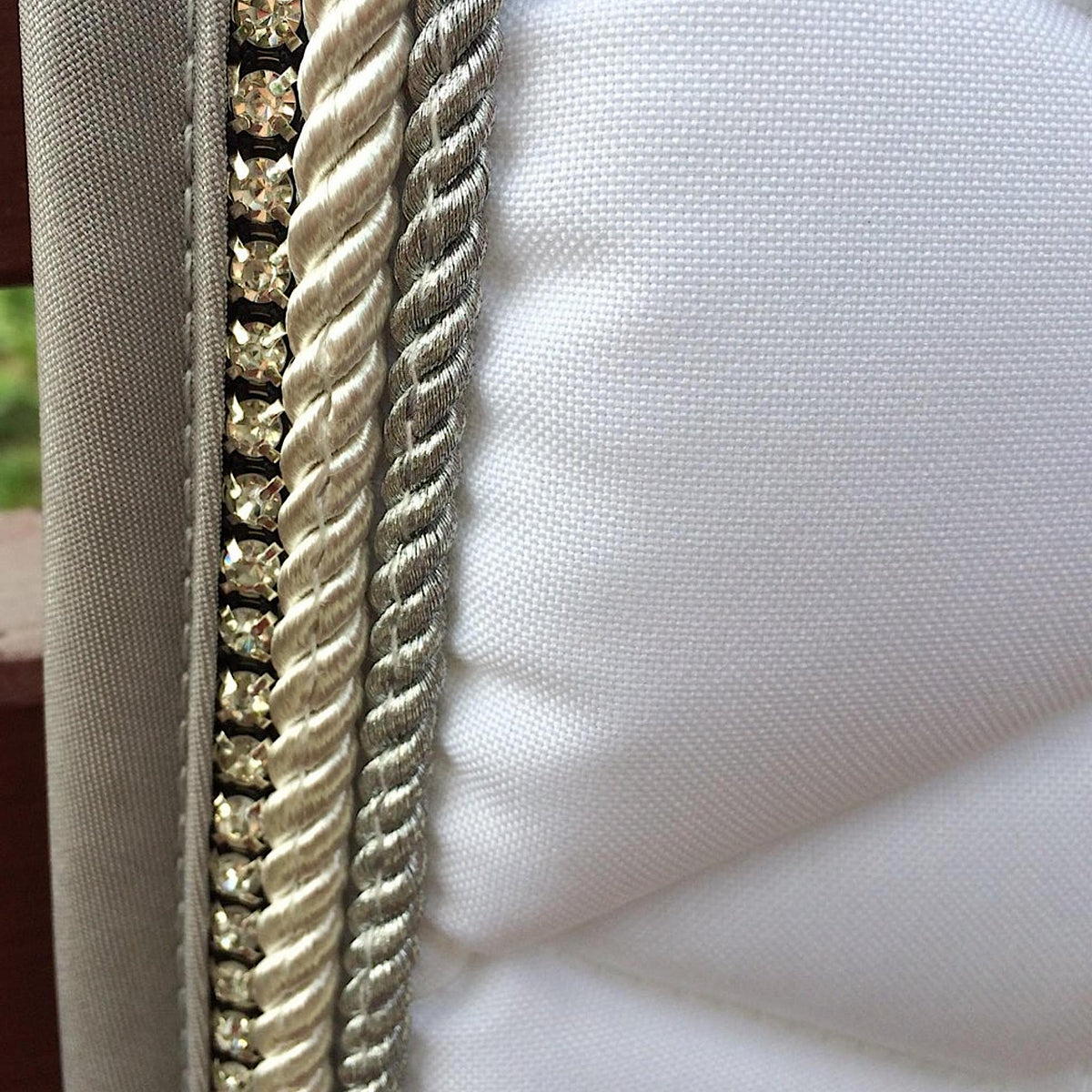 Saddle pad trim; clear diamantes with gold and silver braids, grey edges.