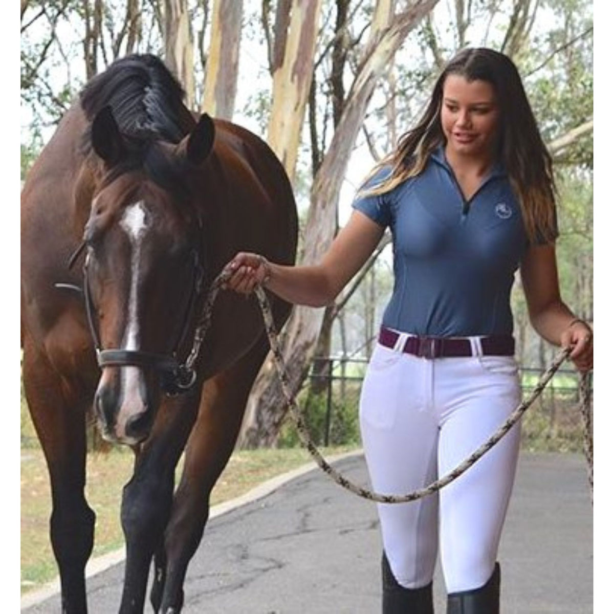 Lady leading horse, wearing grey short sleeve shirt with quarter zip.