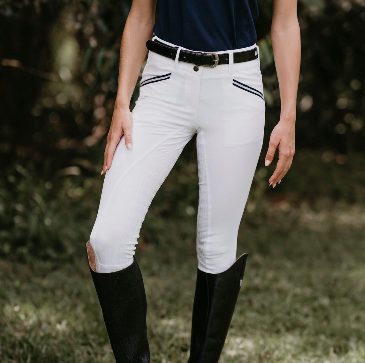 Lady wearing white breeches with navy stripes on front pockets.