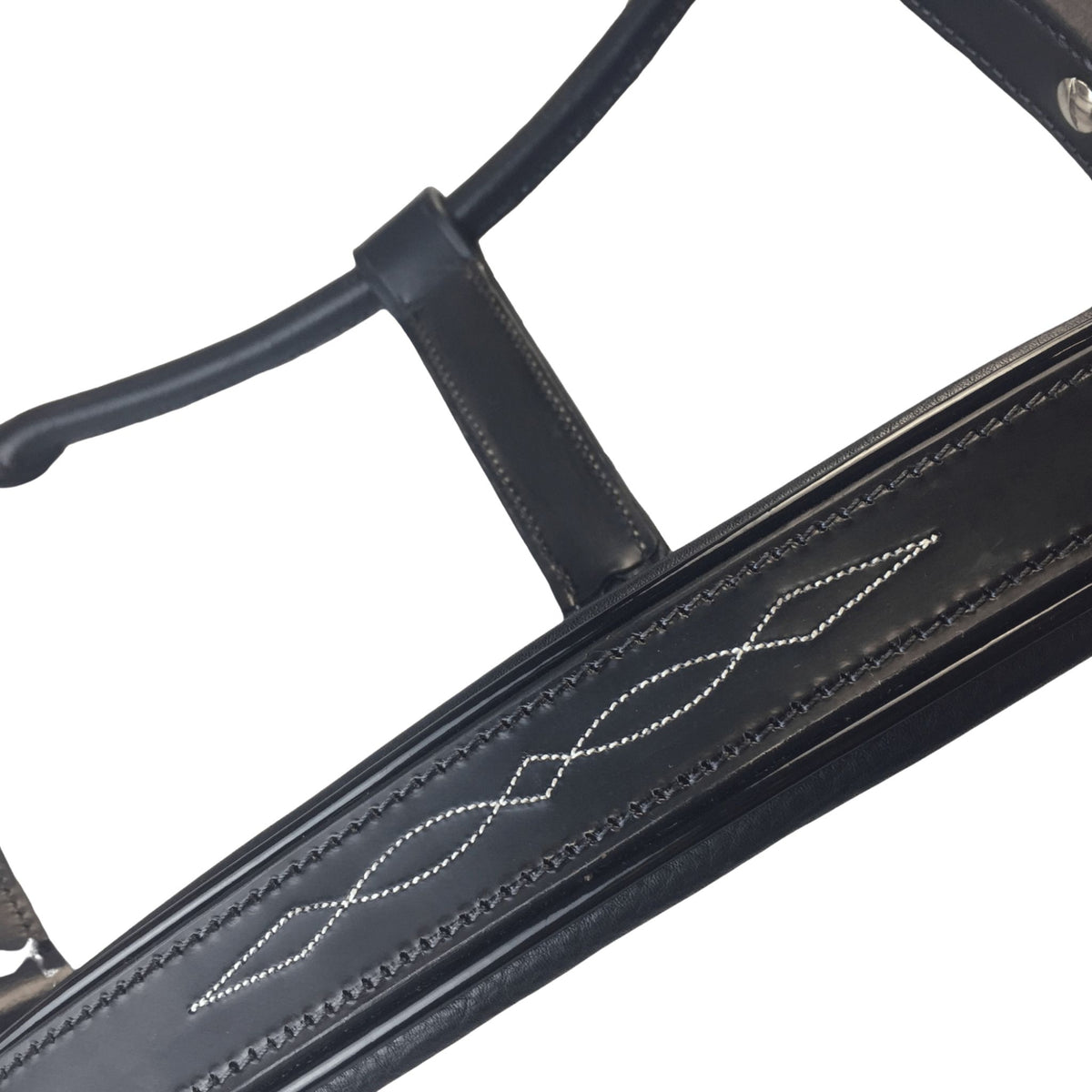 Close up of black leather halter nose band, with white stitched detail.