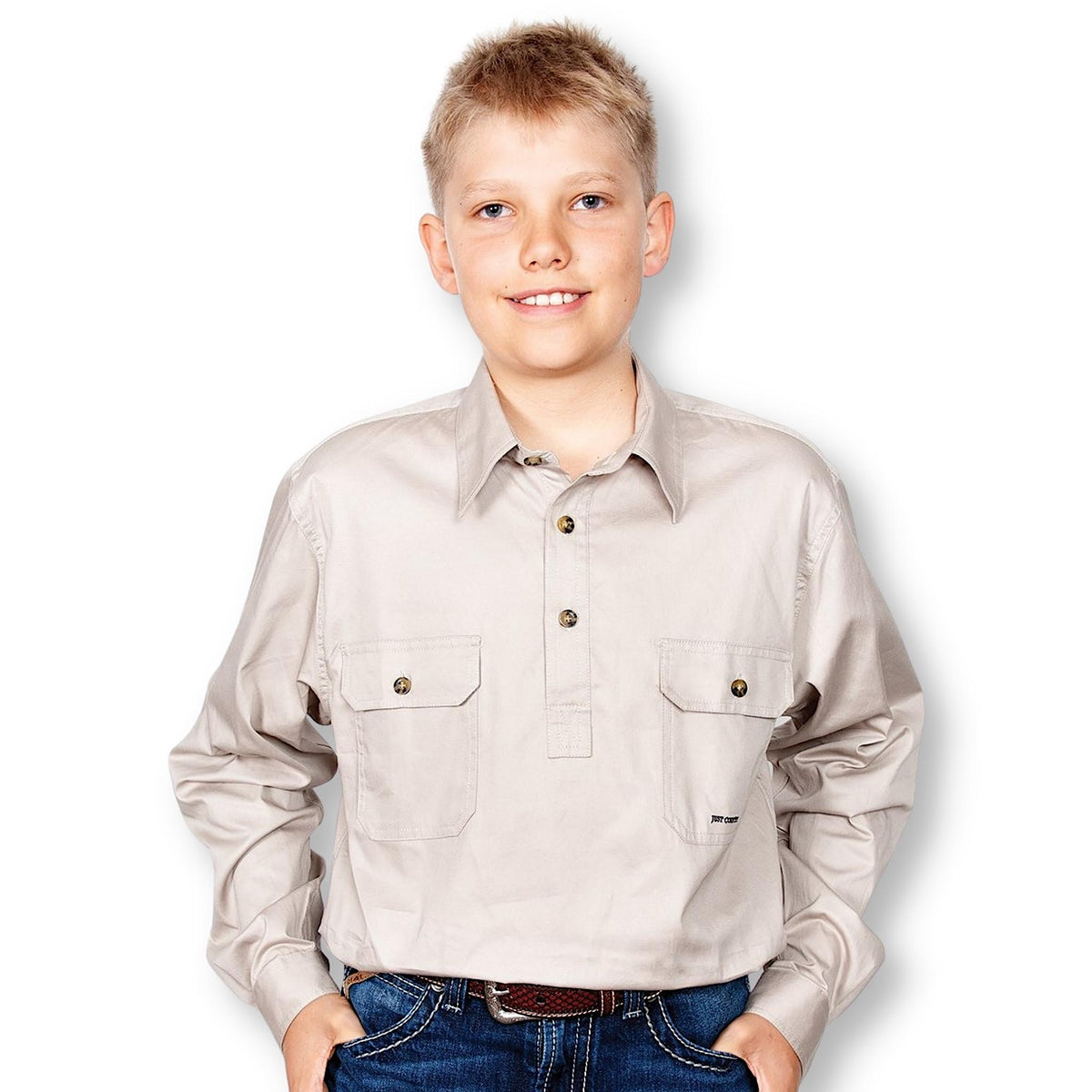 Boy wearing light brown shirt with collar, buttons at top and pockets.