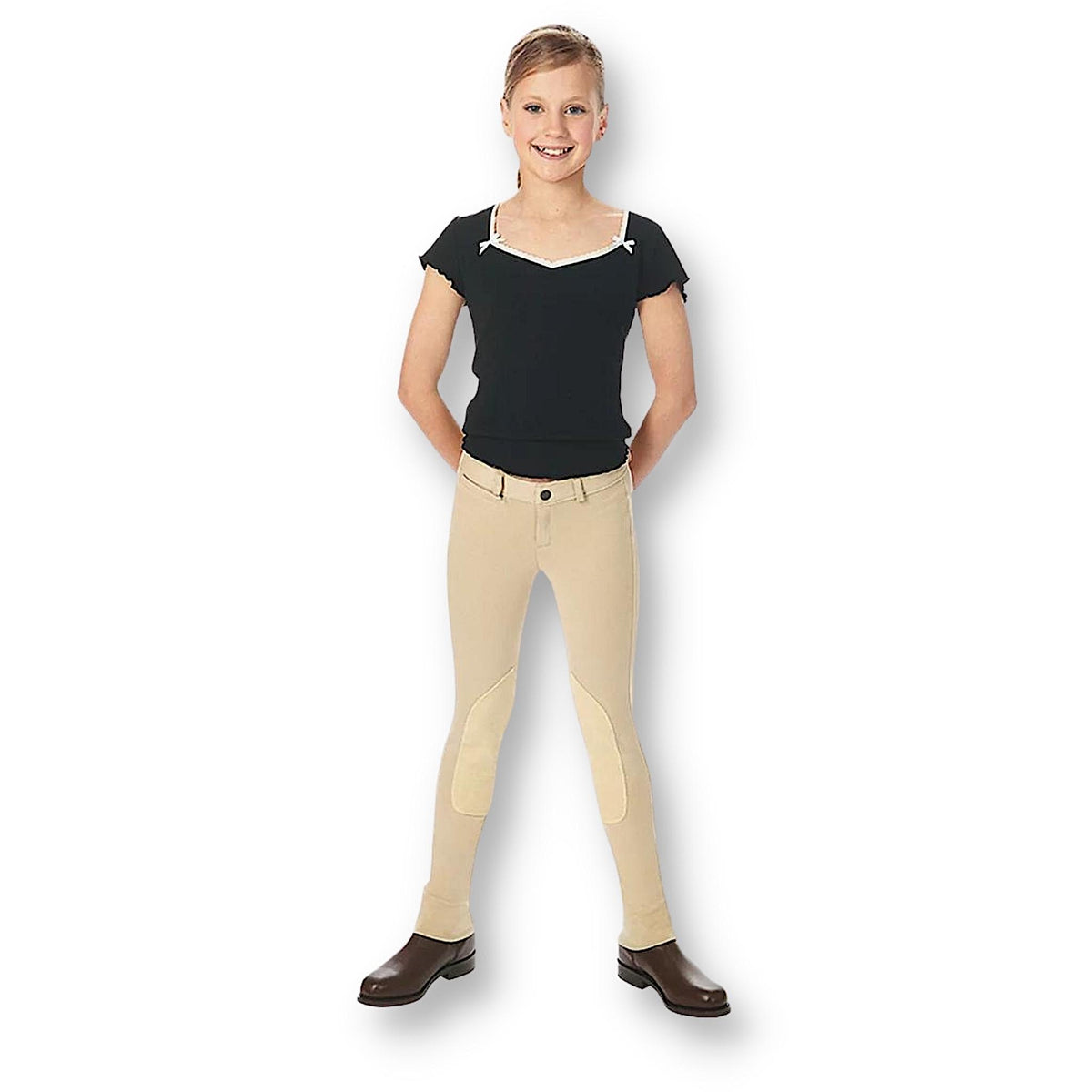 Girl wearing black top with beige jodhpurs and brown boots.