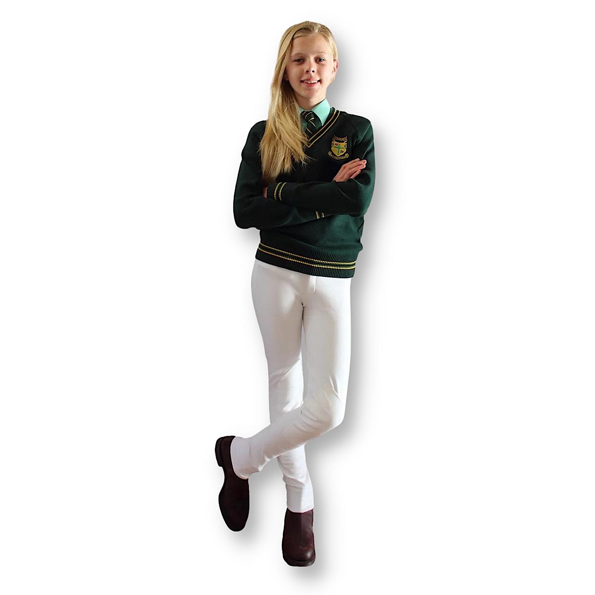 Girl wearing green sweater with white jodhpurs and brown boots.