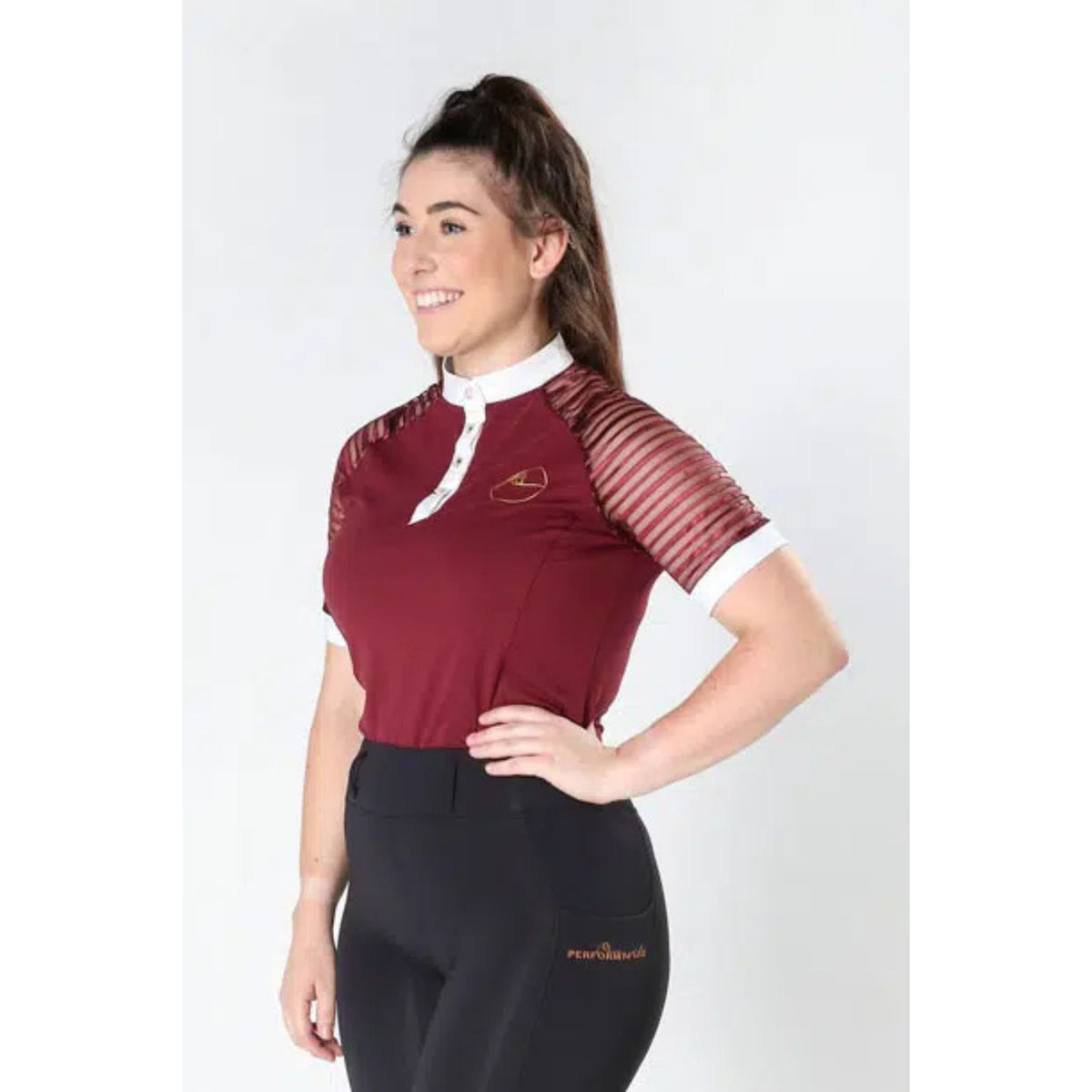 Lady wearing burgundy show shirt with lace sleeves, white cuffs and collar.