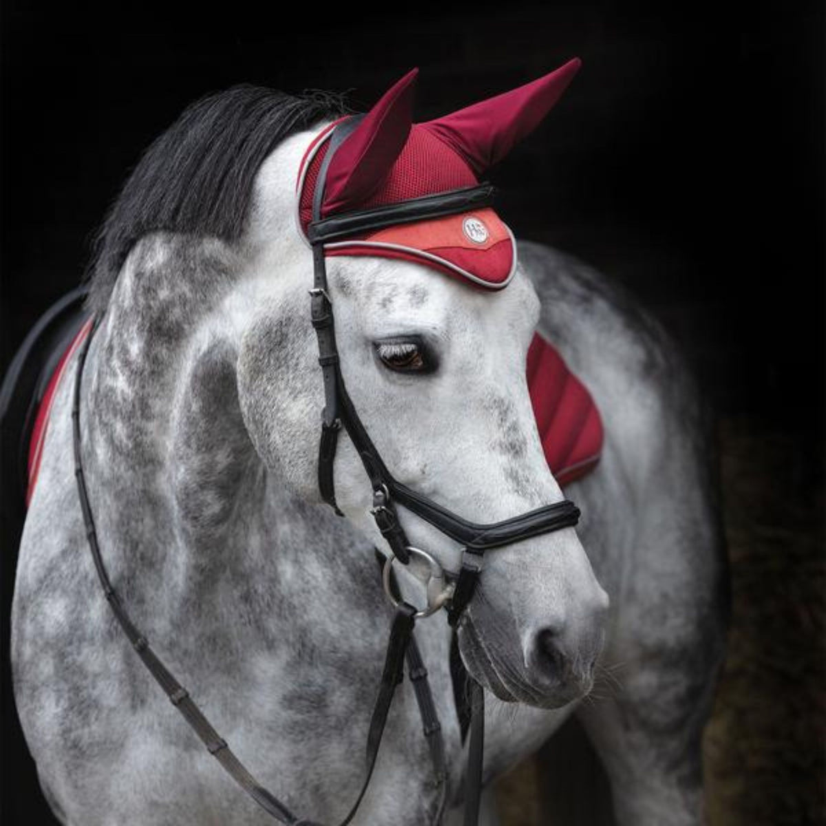 Red air mesh bonnet with grey piped binding and grey horse wear badge.
