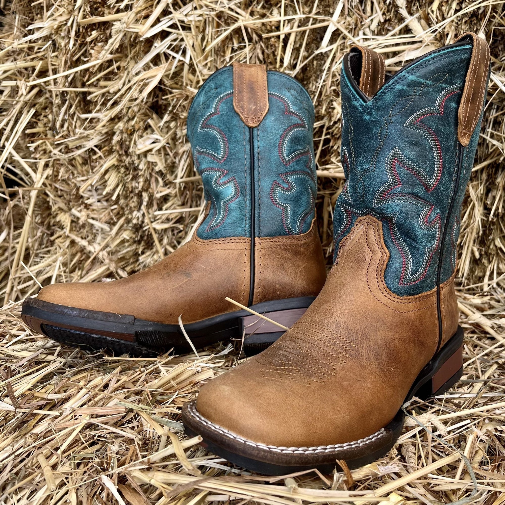 light brown boots with teal blue upper and red and white stitch detailing