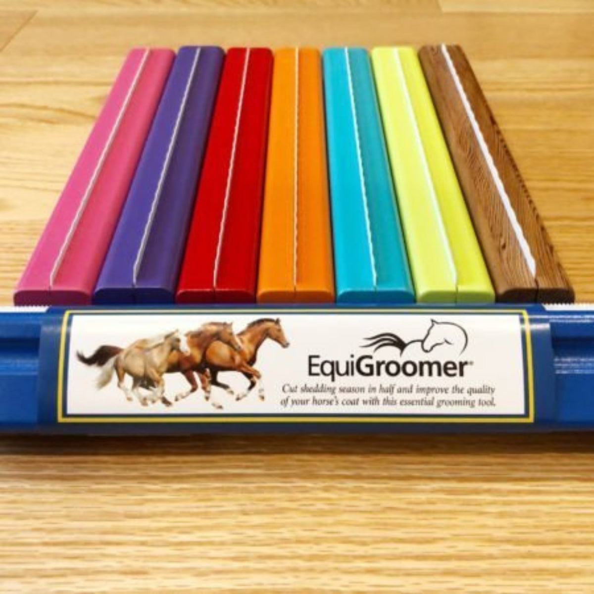Aligned equigroomers of varying colours, with one showing a white wrapped label.