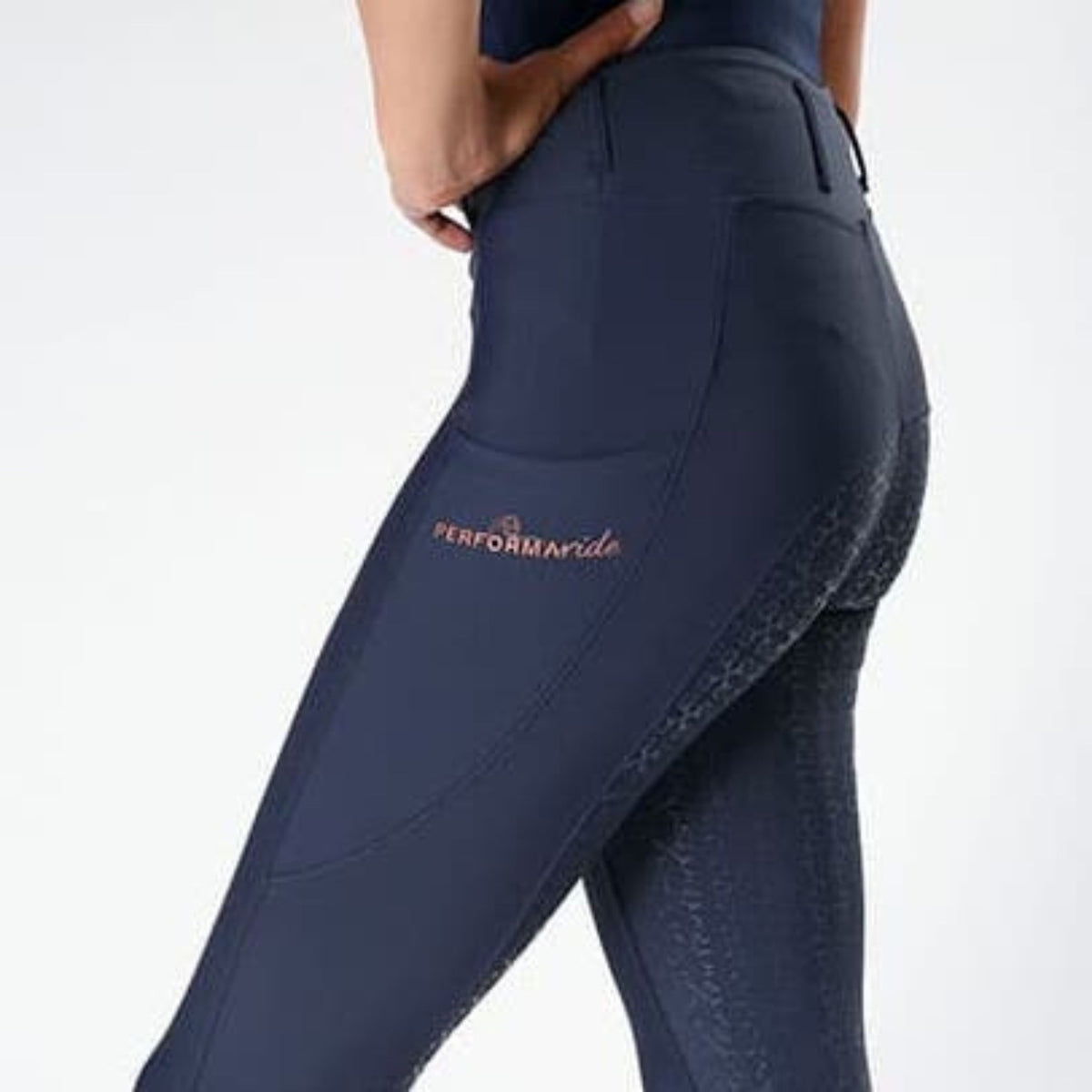 Side view of navy riding tights with phone pocket and grip seat.