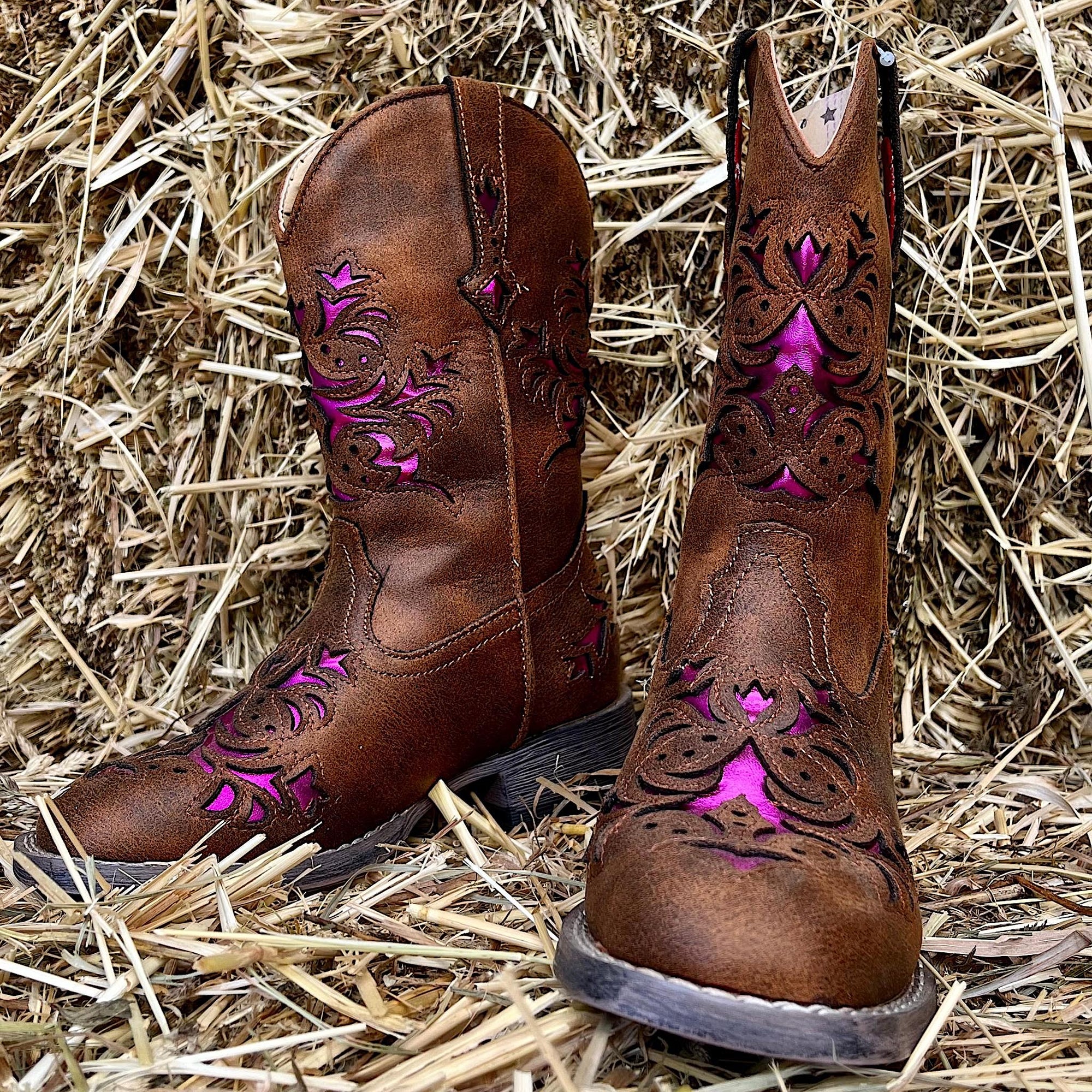 Western boots with pink accents.