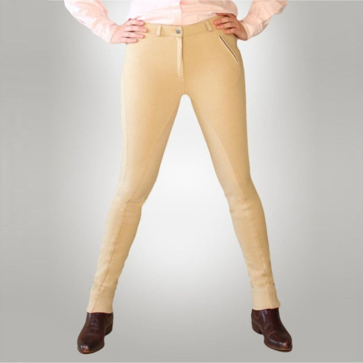 Person wearing beige jodhpurs paired with belt loops on waistband.
